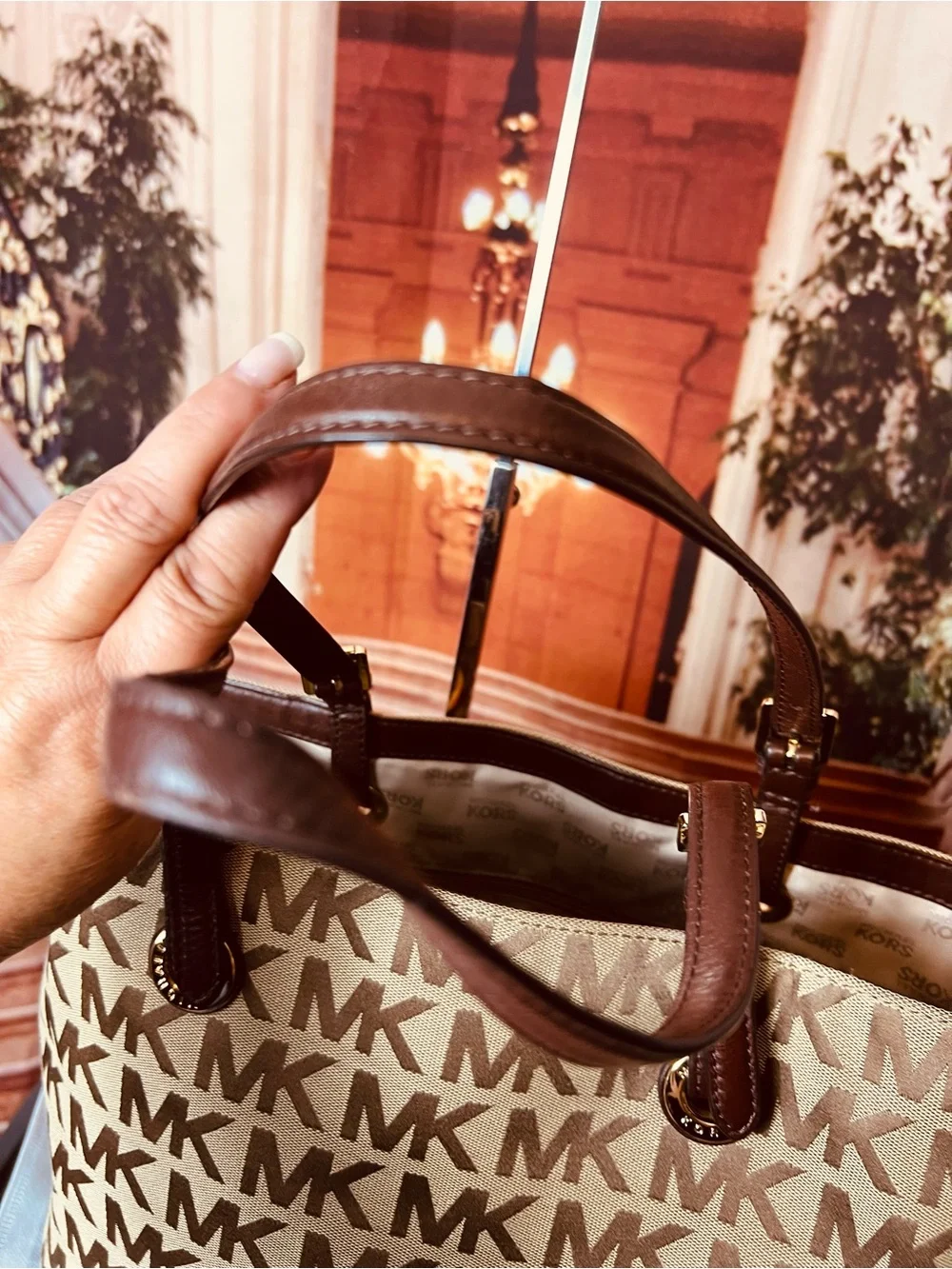 Michael Kors Jet Set tote features monogram canvas, contrasting leather straps